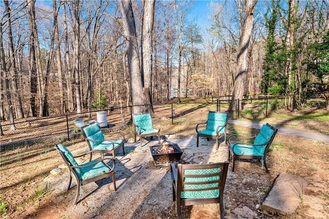 view of yard featuring a patio area, an outdoor fire pit, and fence