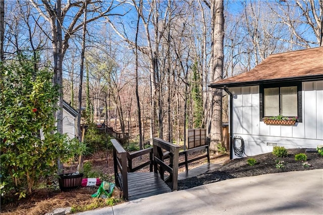 exterior space featuring a shingled roof and crawl space