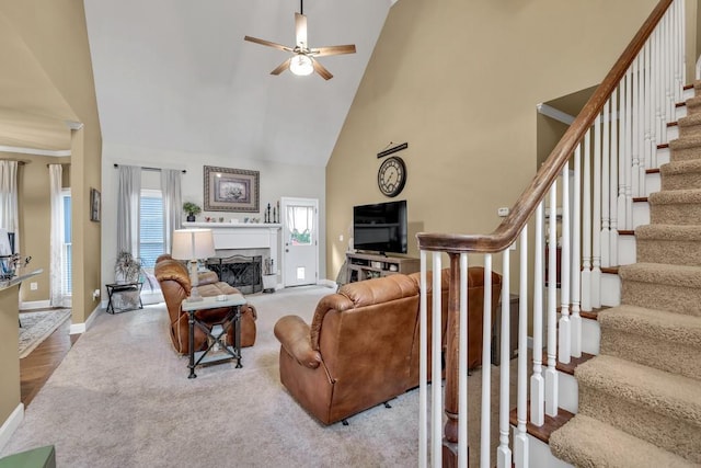 3125 Flatbottom Dr, Dacula, GA 30019 - carpeted living room featuring a ceiling fan, high vaulted ceiling, baseboards, and stairway
