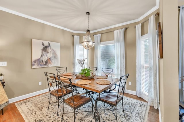 3125 Flatbottom Dr, Dacula, GA 30019 - dining space featuring crown molding, baseboards, wood finished floors, and a chandelier
