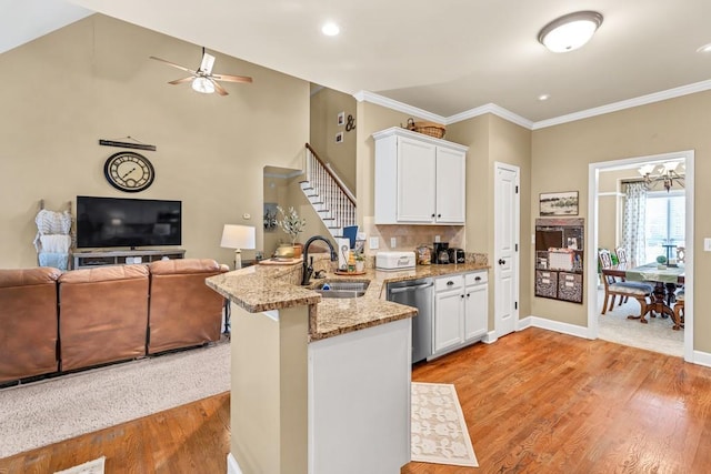 3125 Flatbottom Dr, Dacula, GA 30019 - kitchen featuring a peninsula, open floor plan, white cabinetry, a sink, and dishwasher