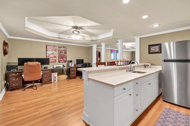 3125 Flatbottom Dr, Dacula, GA 30019 - kitchen featuring decorative columns, crown molding, a sink, a raised ceiling, and freestanding refrigerator