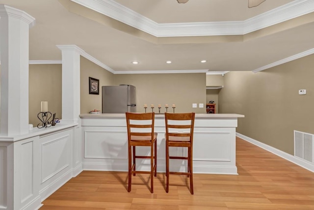 3125 Flatbottom Dr, Dacula, GA 30019 - kitchen with visible vents, freestanding refrigerator, crown molding, a peninsula, and light wood-style floors