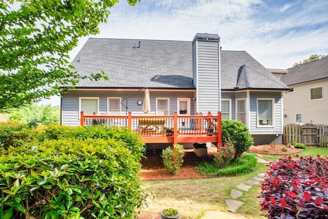 3125 Flatbottom Dr, Dacula, GA 30019 - back of house with fence, a wooden deck, a shingled roof, and a chimney