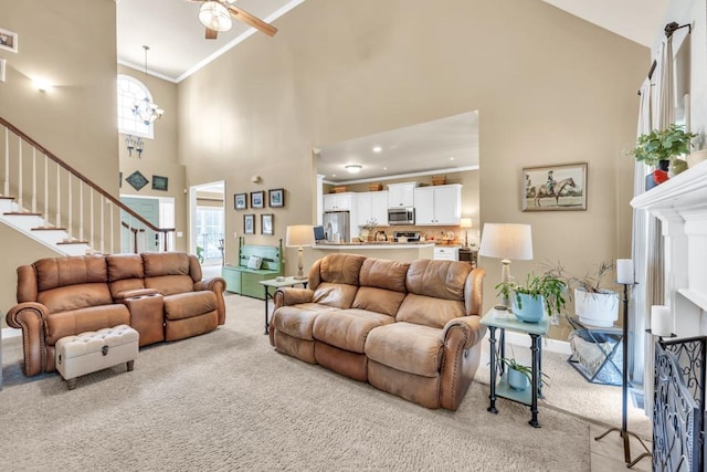 3125 Flatbottom Dr, Dacula, GA 30019 - living room featuring carpet flooring, stairs, ceiling fan with notable chandelier, and high vaulted ceiling