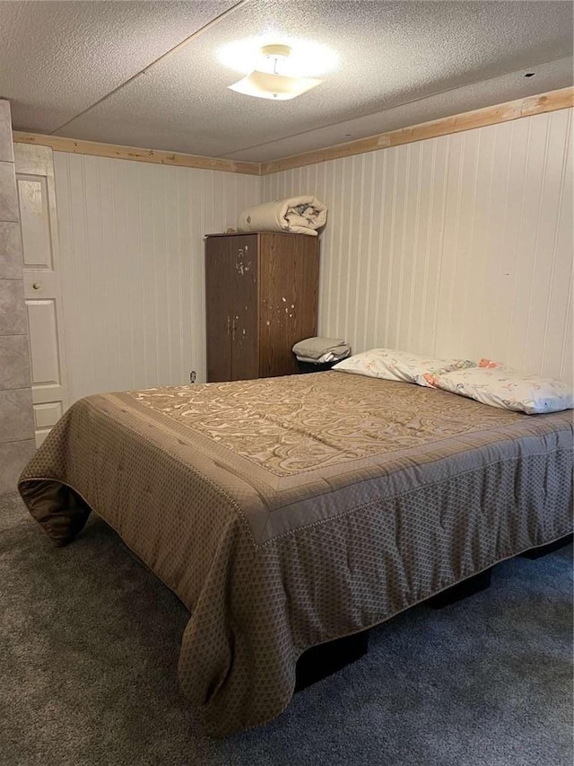 carpeted bedroom with a textured ceiling