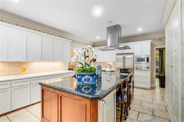 kitchen with built in appliances, ornamental molding, a kitchen island, and island range hood