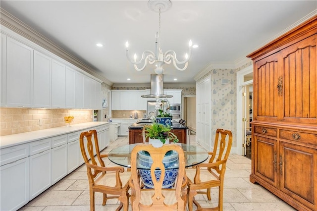 dining space with an inviting chandelier, stone tile floors, ornamental molding, and recessed lighting