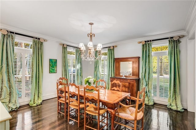 dining space featuring baseboards, ornamental molding, dark wood finished floors, and a notable chandelier