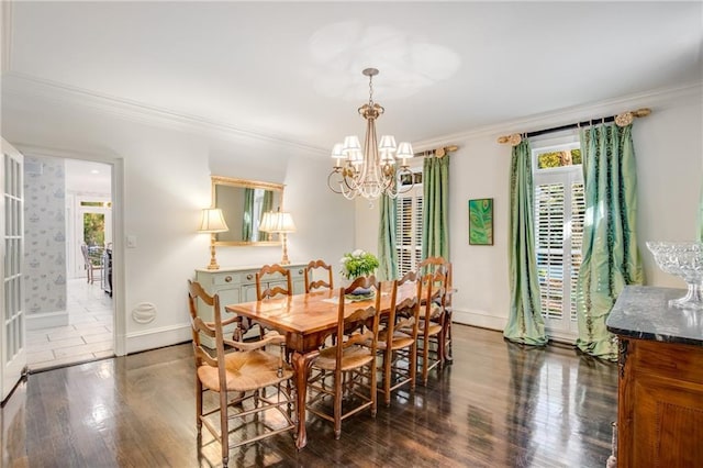 dining room featuring ornamental molding, a wealth of natural light, and wood finished floors