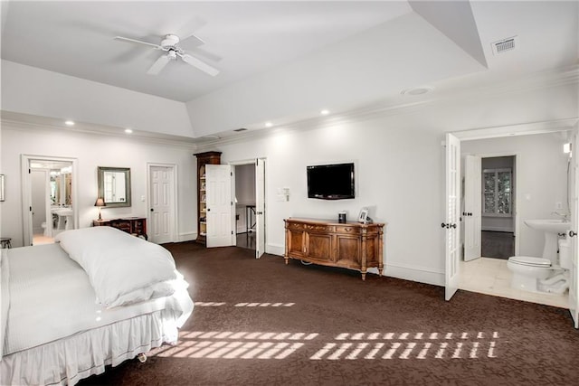 carpeted bedroom featuring ensuite bathroom, recessed lighting, visible vents, ornamental molding, and a raised ceiling