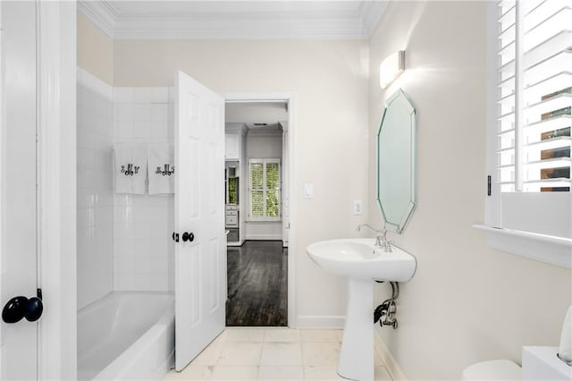 bathroom featuring baseboards, shower / washtub combination, toilet, and crown molding