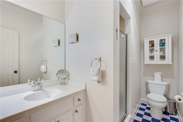 bathroom featuring a shower with shower door, toilet, vanity, tile patterned floors, and crown molding