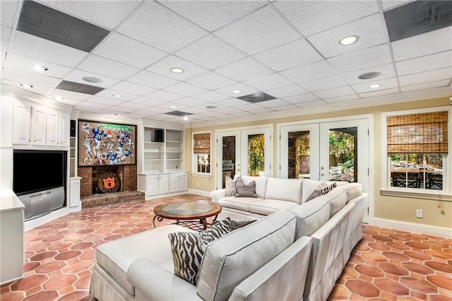 living room with built in features, french doors, a fireplace, recessed lighting, and baseboards