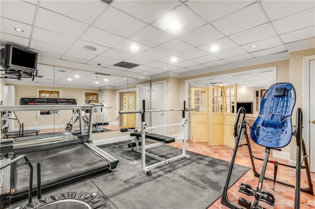 workout area with baseboards, a drop ceiling, and recessed lighting