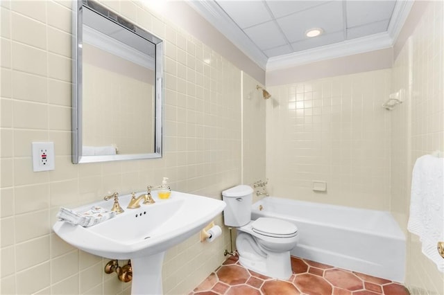 full bath with toilet, tile patterned floors, crown molding, tile walls, and shower / bathing tub combination