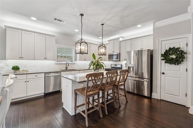 406 Dunaway Ct, Grayson, GA 30017 - kitchen featuring appliances with stainless steel finishes, recessed lighting, light stone countertops, backsplash, and dark wood-style floors