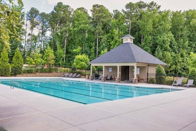 406 Dunaway Ct, Grayson, GA 30017 - community pool featuring a patio area and view of wooded area