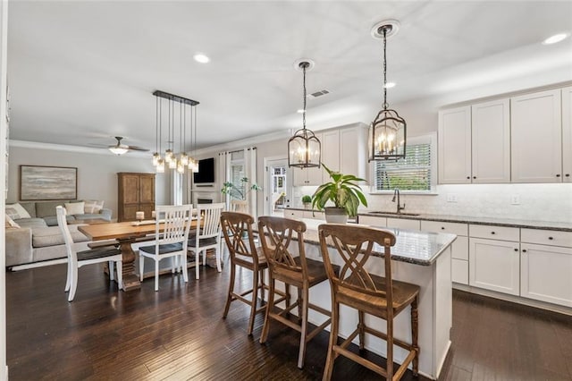 406 Dunaway Ct, Grayson, GA 30017 - kitchen with ornamental molding, a chandelier, decorative backsplash, recessed lighting, and light stone counters