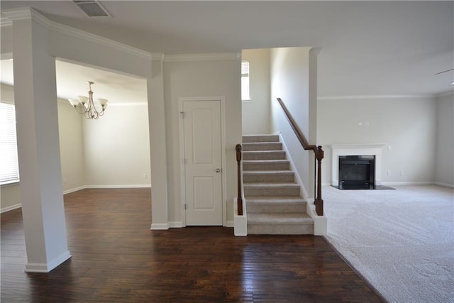 staircase with visible vents, a healthy amount of sunlight, wood finished floors, and crown molding