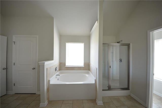 bathroom featuring a garden tub and a stall shower