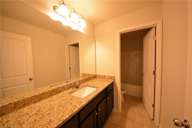 bathroom featuring vanity, tile patterned floors, and toilet