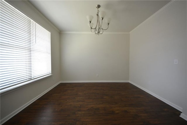 empty room with dark wood finished floors, a notable chandelier, baseboards, and ornamental molding