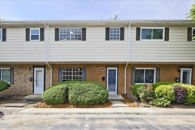 view of property featuring brick siding
