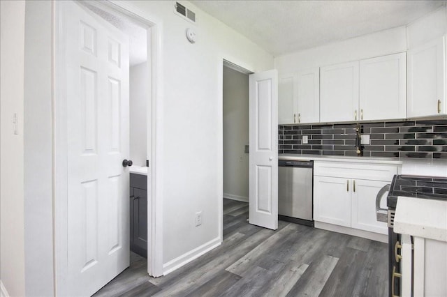 kitchen featuring dishwasher, light countertops, range with electric cooktop, white cabinetry, and visible vents