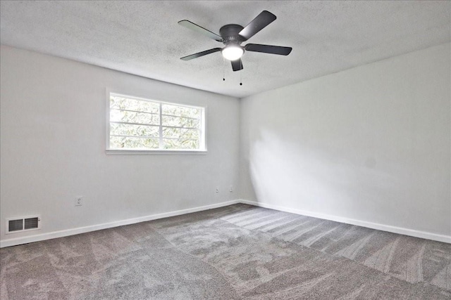 empty room featuring a ceiling fan, baseboards, visible vents, and carpet