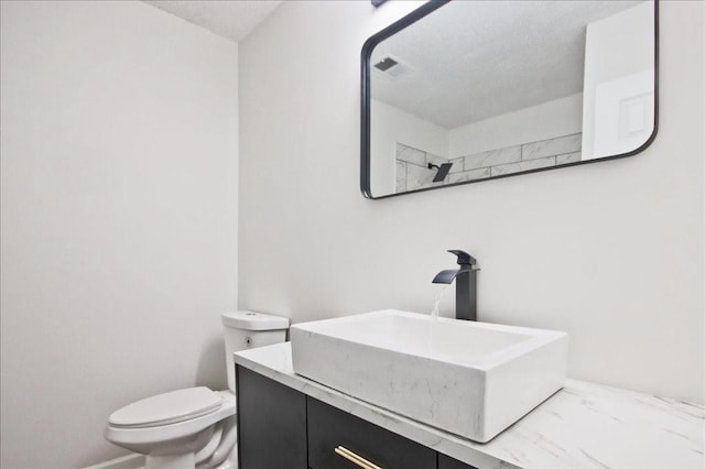 bathroom with visible vents, marble finish floor, toilet, and vanity