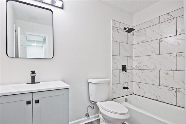 bathroom featuring toilet, baseboards, tub / shower combination, and vanity