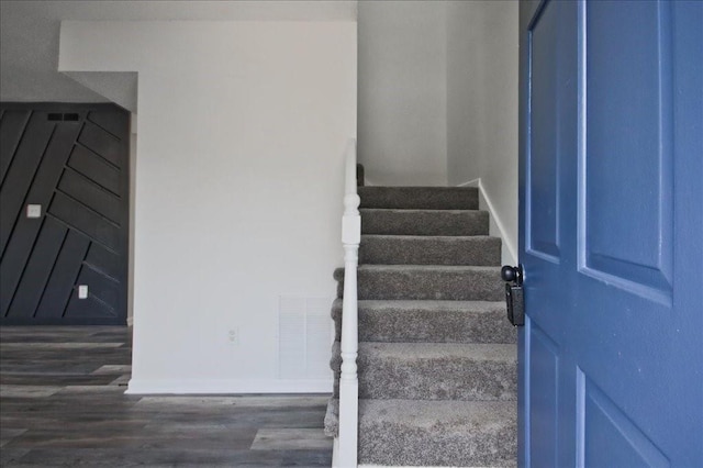 stairway featuring visible vents