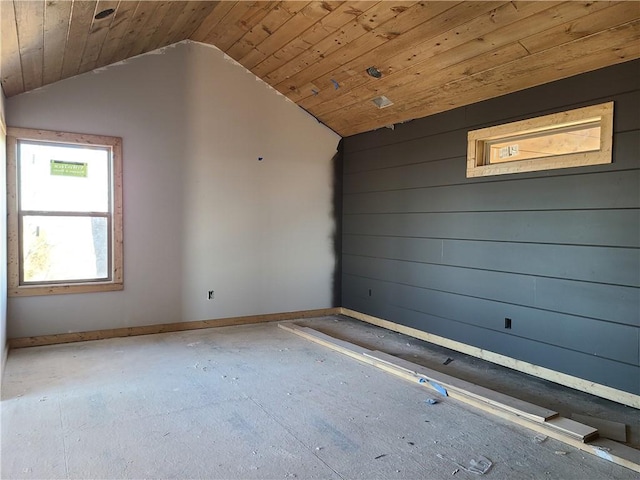 spare room featuring lofted ceiling, wooden ceiling, and baseboards