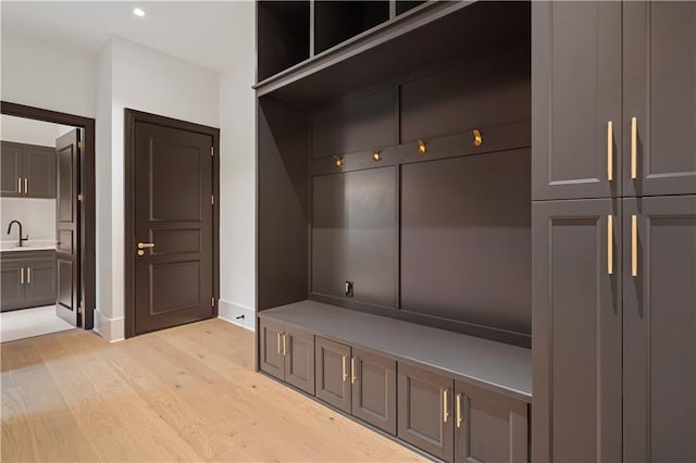 mudroom featuring sink and light hardwood / wood-style flooring