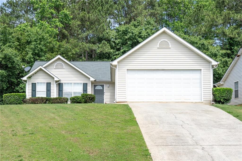 148 Willow Springs Ln, Stockbridge, GA 30281 - ranch-style home featuring a front lawn, view of scattered trees, and driveway