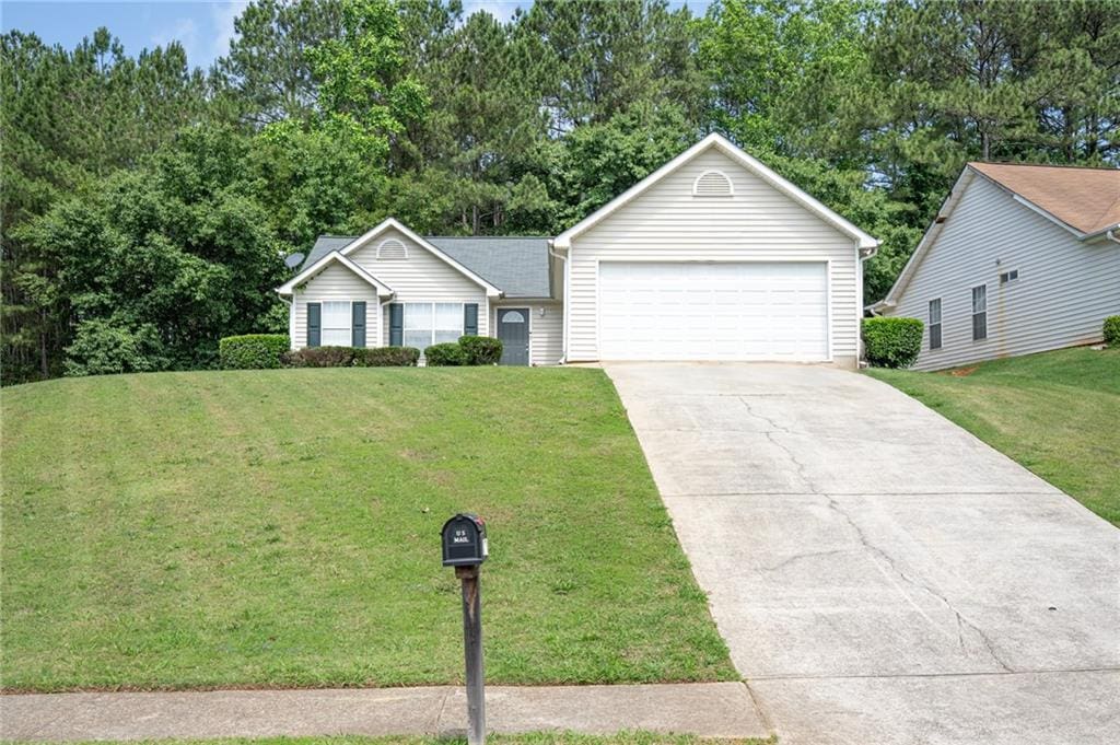 148 Willow Springs Ln, Stockbridge, GA 30281 - ranch-style house featuring a front yard and view of wooded area