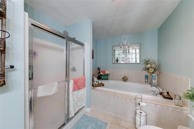 bathroom with a textured ceiling, independent shower and bath, an inviting chandelier, and tile patterned floors