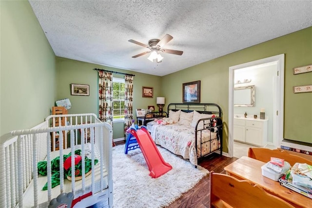 bedroom featuring a textured ceiling, wood-type flooring, connected bathroom, and ceiling fan