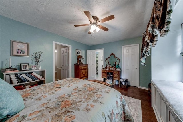 bedroom with ceiling fan, dark wood-type flooring, and a textured ceiling