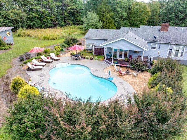 view of swimming pool featuring a yard and a patio area