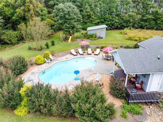 view of pool with a patio and a yard