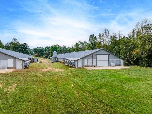 view of yard featuring cooling unit and a garage