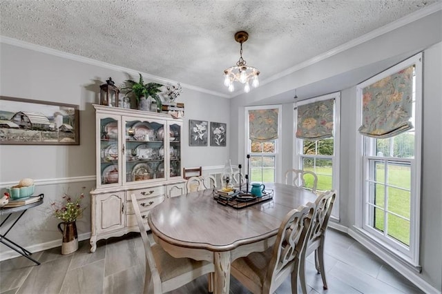 dining room with a textured ceiling, tile patterned flooring, ornamental molding, and an inviting chandelier