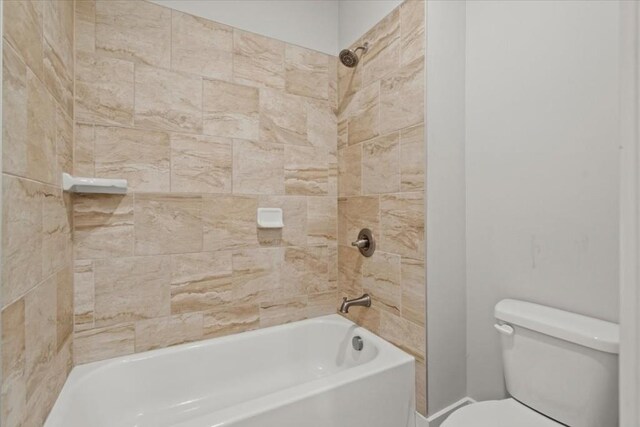 bathroom featuring washtub / shower combination and toilet