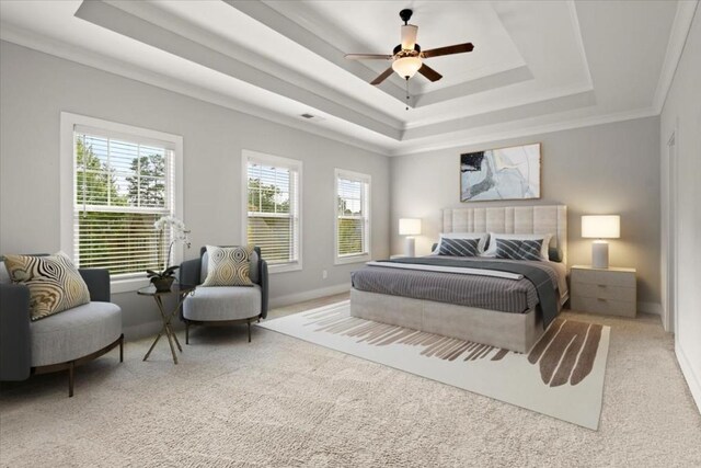 bedroom with carpet floors, a tray ceiling, and baseboards