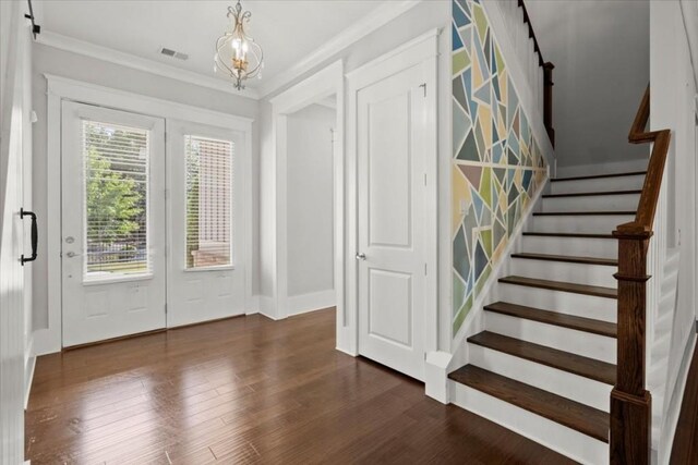 foyer entrance featuring ornamental molding, stairway, dark wood-style flooring, and visible vents