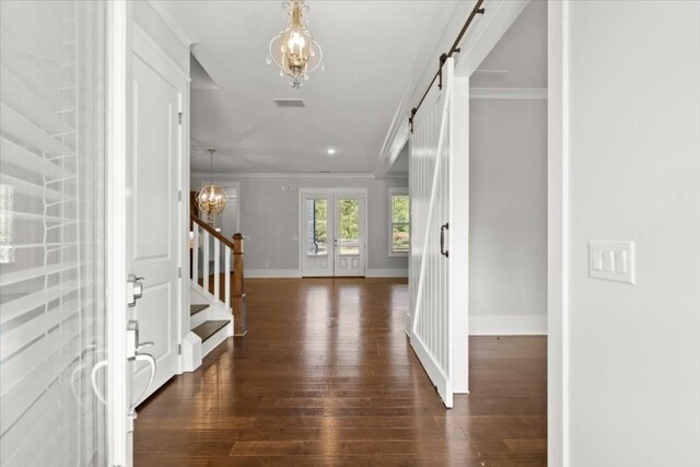 foyer featuring a chandelier, ornamental molding, stairs, and visible vents