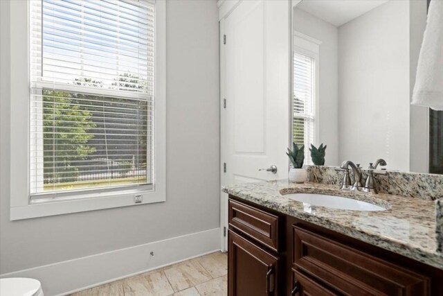 bathroom with vanity and baseboards