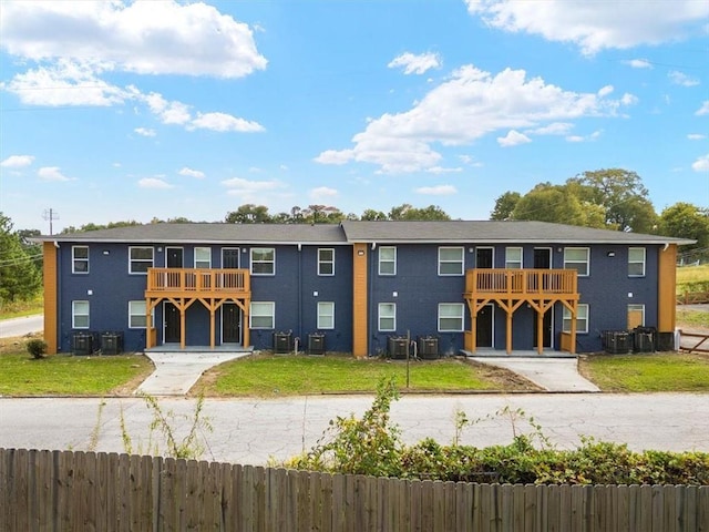 view of front of house with a balcony and cooling unit